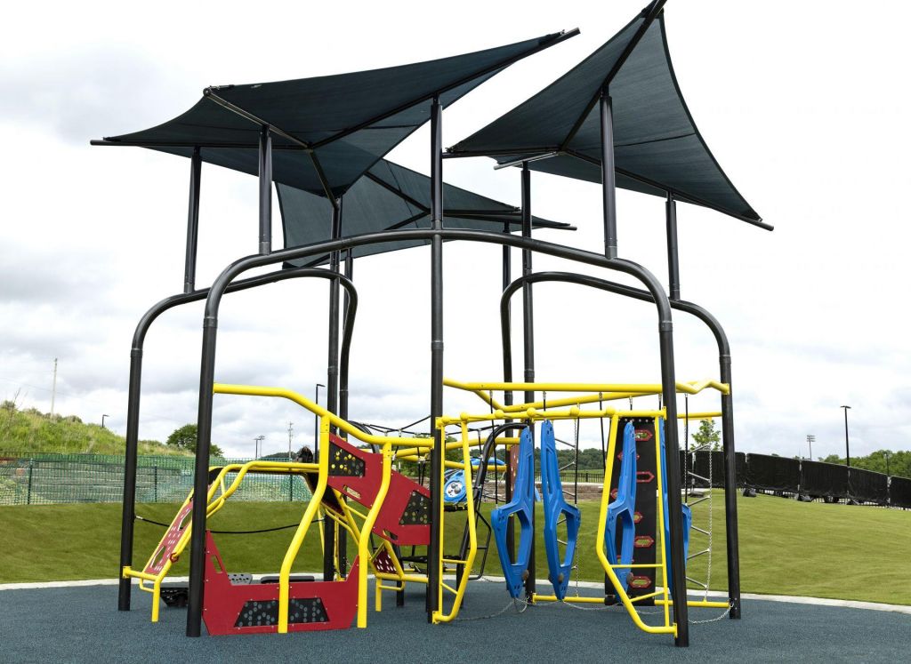 Shade over youth obstacle climbing equipment