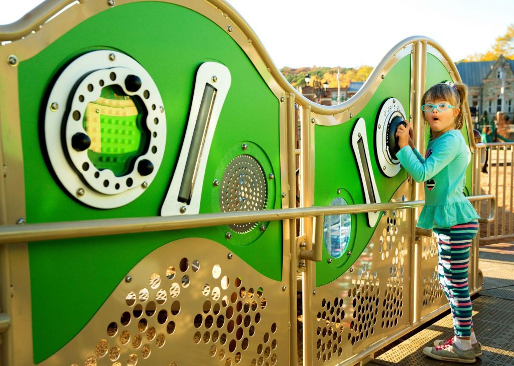 Child playing on level appropriate sensory play ramp