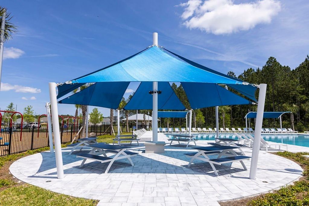 Sail Shade and picnic tables near pool and playground