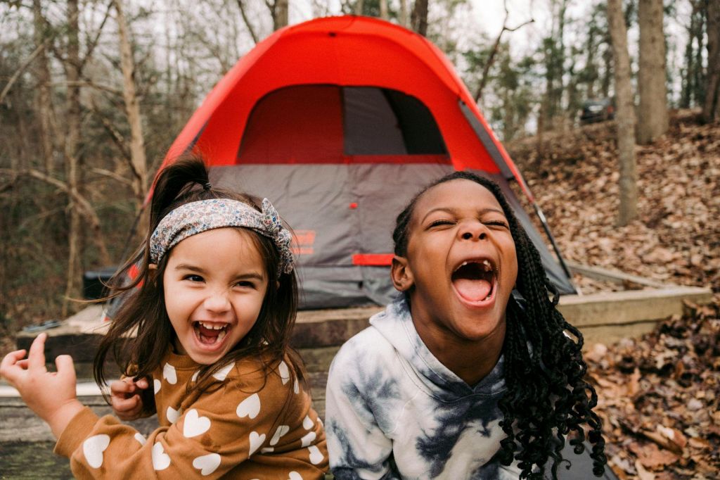 Two young girls having fun while camping